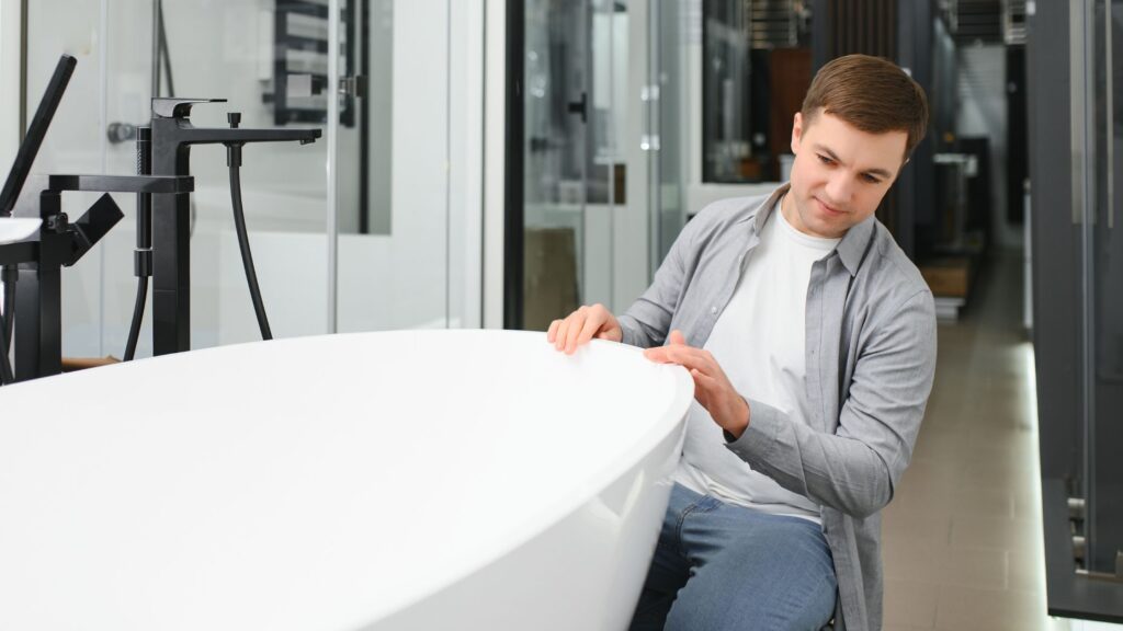 Homeowner examining a tub restoration, thinking about how long does it take to resurface a tub